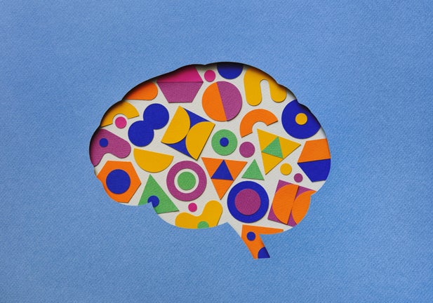 Paper craft illustration of brain filled with multi colored geometric shapes. Creative mind/