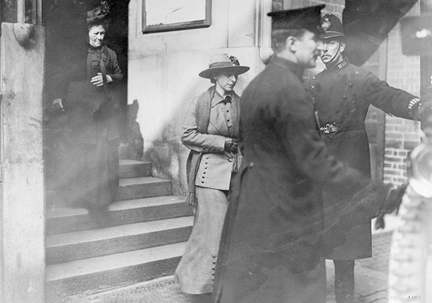 'Slasher' Mary Richardson leaving court, 1914. Richardson (centre), had attacked the Rokeby Venus at the National Gallery in London on 4th March 1914, slashing it seven times with a meat cleaver. This was in protest at the government's failure to give women the vote. Attacks on works of art prompted the closure of many of the country's art galleries and museums to women, and sometimes to the public completely. At places of historical interest the rule of 'No muffs, wrist-bags, or sticks' was widespread. Later, in May 1914, the Royal Academy and the Tate Gallery closed to the public. The British Museum was more flexible, opening to women accompanied by men who would accept responsibility for them. Unaccompanied women were only allowed in if they had a letter of recommendation from a gentleman who would vouch for their good conduct and take responsibility for their actions. (Photo by Museum of London/Heritage Images/Getty Images)/