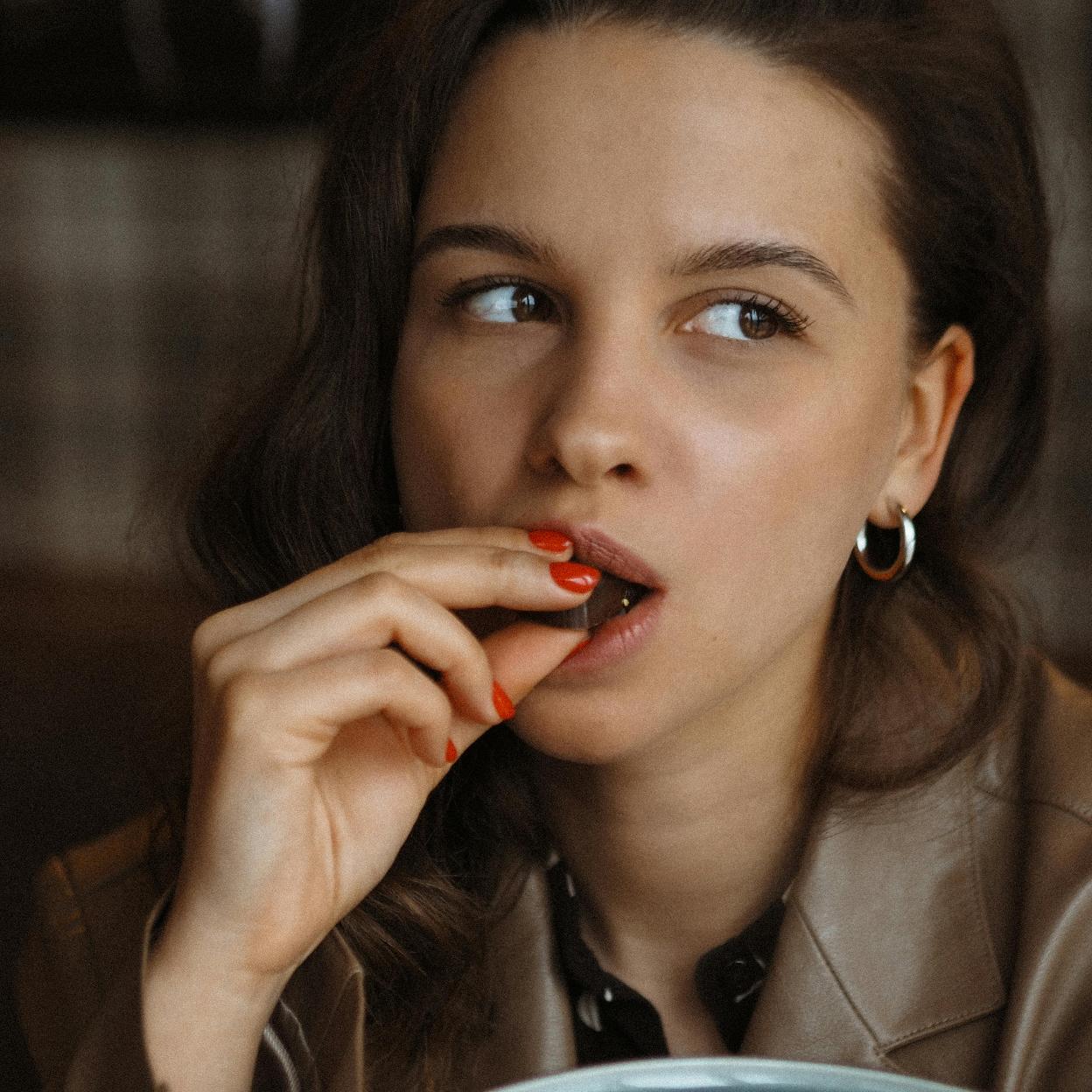 Mujer comiendo chocolate/pexels