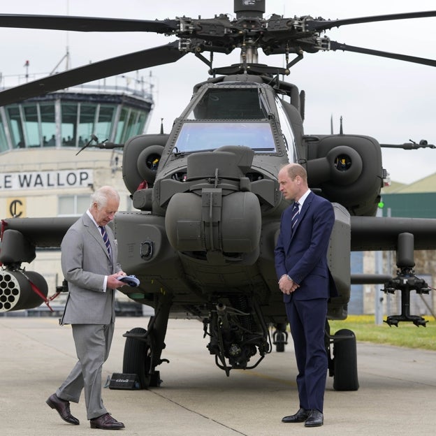 Guillermo junto a su padre y frente a un helicóptero. 